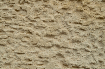 Old stone wall with limestone erosion closeup in Lecce, Italy