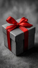 Black and white photo of detailed gift box with red ribbon