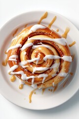 Delicious cinnamon bun with golden baked swirls, topped with creamy white icing and caramel drizzle on a white plate