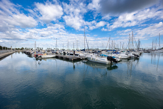 Boats moored in denia marina under blue sky