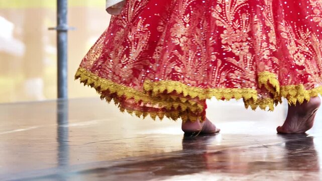 Indian bride wearing traditional red lehenga with intricate golden embroidery at a ceremony