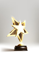 A shining golden star trophy on a black base, with metallic facets glowing against a gray background, symbolizing achievement and excellence.