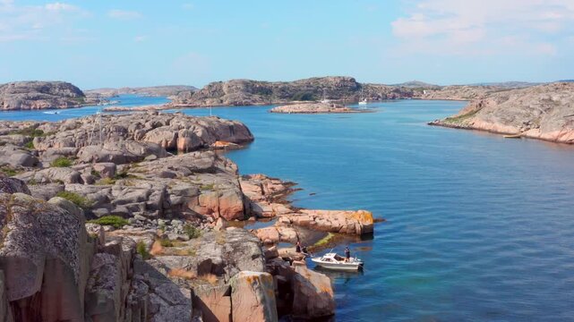 Idyllic west coast of Sweden. Islands rocky stones aerial drone. Small boat in archipelago. Sm&ouml;gen, Marstrand, Lysekil, the Koster Islands, Fj&auml;llbacka, Grebbestad Str&ouml;mstad theme