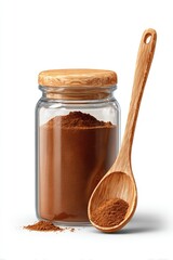 Glass jar filled with ground cinnamon and a wooden spoon resting beside it with a small heap of the aromatic spice