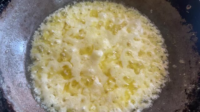 Reducing milk cream in a pan.