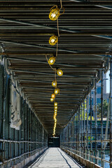 Lighting in protective scaffolding for pedestrian walkway