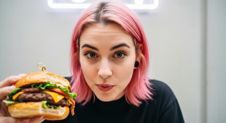 Blonde young woman smiling while holding and eating a piece of cake