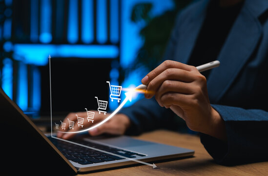 E-commerce Growth and Online Sales Increase Concept. A person draws an upward arrow graph with shopping cart icons, symbolizing steady rise of ecommerce sales and online retail growth. sell target,
