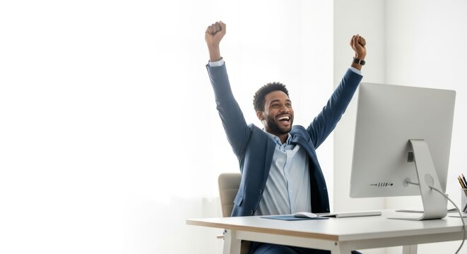 Happy african american businessman celebrating success in modern office
