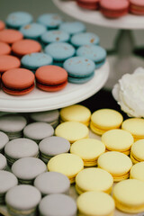 exquisite tiered arrangement showcasing delicate macarons and floral accents in romantic setting