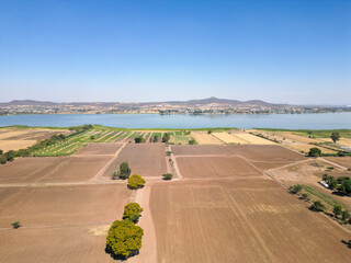 Wide aerial panorama showing cultivated fields and Cajititlan Lake in San Lucas Evangelista Jalisco Mexico