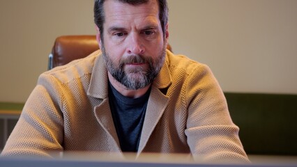 Middle Aged Male Business Analyst Sorting Through Graphs and Charts Preparing for Executive Presentation - Business Analysis Concept