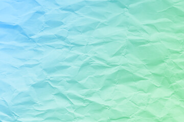 Crumpled turquoise green blue paper texture background. Wrinkled paper surface abstract background.