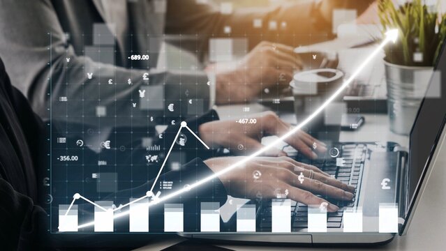 A dynamic scene of business professionals engaged in financial analysis with a digital graph overlay. The image represents growth, collaboration, and success in a modern office setting. Copula