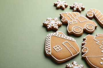 Christmas treat. Tasty gingerbread cookies on green background, closeup. Space for text