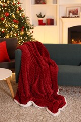 Stylish room with Christmas tree, sofa and armchair. Interior design