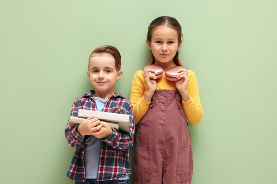 Cute little kids with books and headphones on pale green background - Powered by Adobe