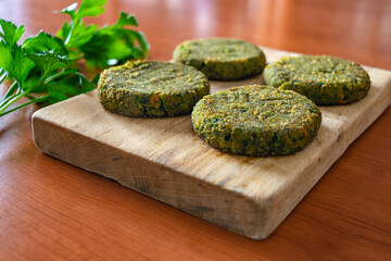 Vegan burger patties placed on a wooden table, low-angle view