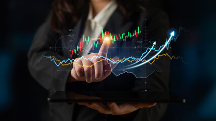 A business professional engages with financial data on a digital tablet, showcasing graphs that illustrate stock market trends and growth projections in a modern analysis setting. Scalp