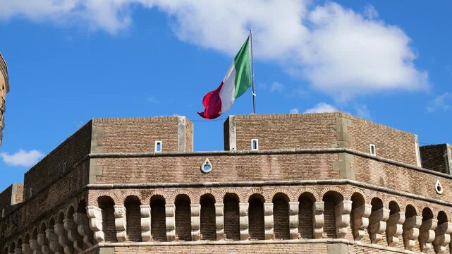 italian flag flies atop castel sant'angelo's upper against cloudy sky mausoleum hadrian rome front of historic landmark monumental architecture 