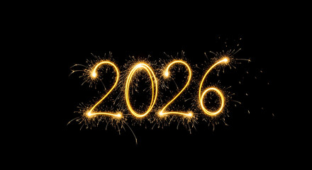 Year two thousand and twenty six written with sparklers on a black background for new year celebration