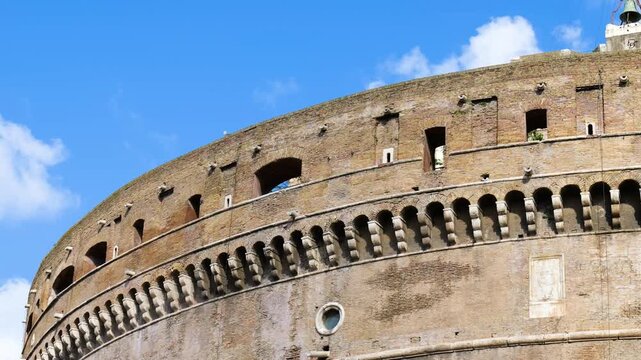 castel sant'angelo bricked walls arches windows under cloudy sky rome closeup side view mausoleum of hadrian historic landmark monumental architecture 