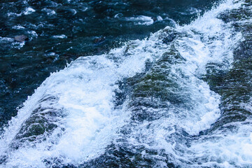 The natural beauty of Mesa Falls shines as rushing water contrasts with the peaceful wilderness around it.