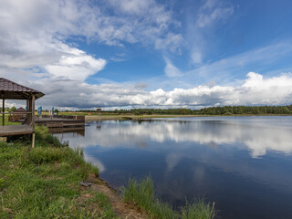 Fototapeta premium Lake with a wooden dock and a gazebo