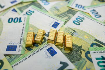 Gold bullion bars with euro cash, concept of rich lifestyle, financial independence and prosperity