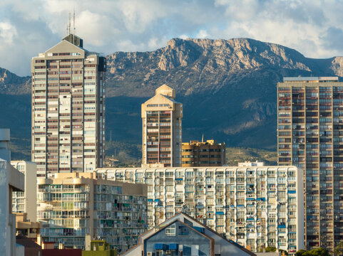 Aerial view of Benidorm, Spain, showcasing high-rise buildings and the Mediterranean Sea in the background.