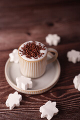 cozy beverage scene with cocoa topped mug surrounded by snowflake marshmallows on rustic wooden table, emphasizing warmth and comfort in soft, neutral tones, stylish, fluffy, design, interior