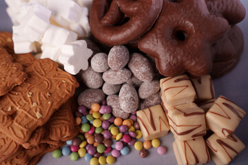a delectable assortment of sweet treats including chocolate-covered pretzels, colorful candies,...