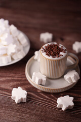 warm cappuccino with chocolate sprinkles and star-shaped marshmallows on a rustic wooden table, invoking comfort and indulgence in a cozy home setting, creative, appetizing, delicious, brunch