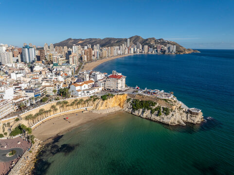 Aerial view of Benidorm, Spain, showcasing high-rise buildings and the Mediterranean Sea in the background.