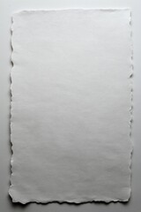 A Blank Canvas of White Paper Featuring a Torn Edge, Ideal for Creative Expression and Artistic Projects in Various Mediums