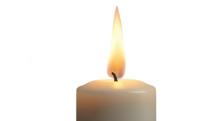 Lit candle with a bright flame provides soft light in a dark setting