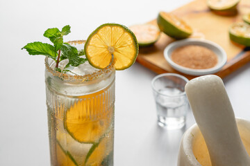 Prepared Mandarin Lime Mojito on White Background with Cocktail Ingredients
