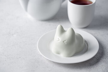 Vanilla panna cotta in the form of cat in a plate