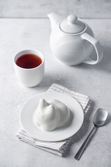 Vanilla panna cotta in the form of cat in a plate