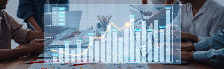A business team engaged in analyzing financial data reports with various graphs and charts during a...