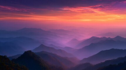 Fototapeta premium Layered mountains under a vibrant sunset sky creating an atmospheric landscape with purple and orange hues