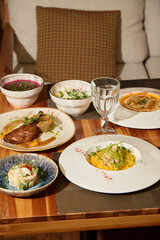 Experience a stunning gourmet meal presentation beautifully arranged on a rustic wooden table