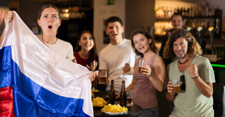 Football fans gesturing emotionally after goal scored by favorite team while watching championship...