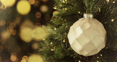 Merry Christmas and Happy Holidays greeting card. Christmas tree with ball and string lights,...