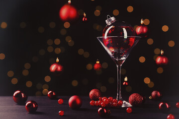 Christmas ball cocktail and bokeh lights on black background. Happy holidays greeting card