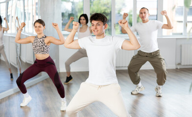 Naklejka premium Team of dancers performing contemporary dance in ball room
