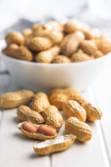 Peanuts in shell. Groundnuts on white table.