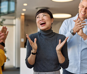Portrait of a businesswoman celebrating during a meeting in office, group of businesspeople celebrating success, applauding and smiling, teamwork concept