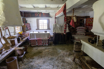 Traditional rural house interior with handcrafted decor and hay floor