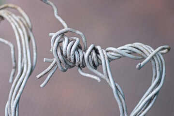 a piece of white old aluminum wire on a brown background